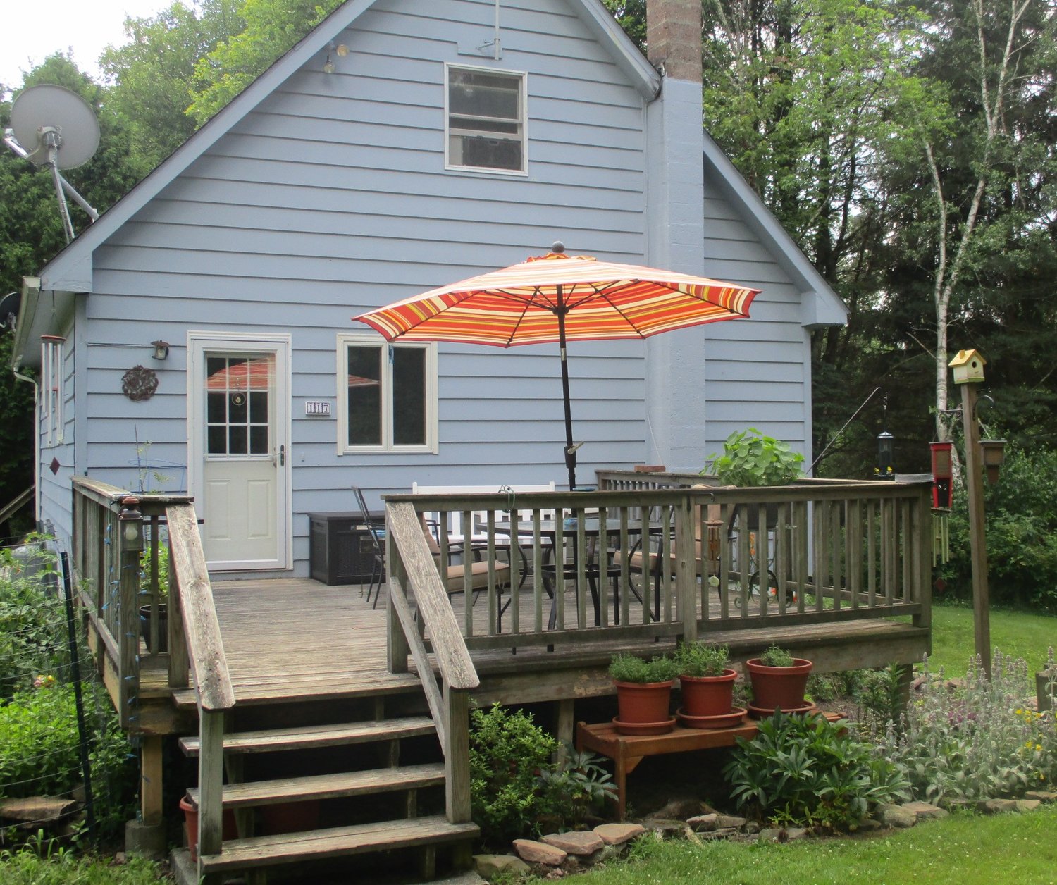 Front of house with umbrella.